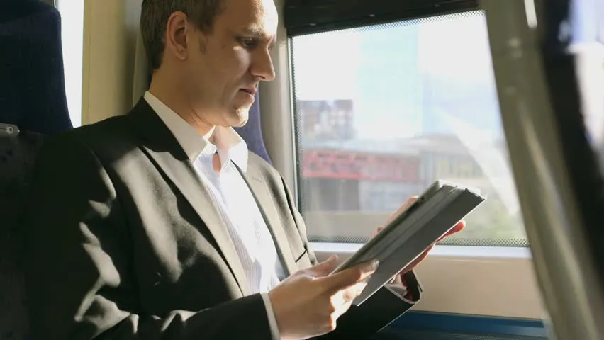 iPad Man Playing on Train